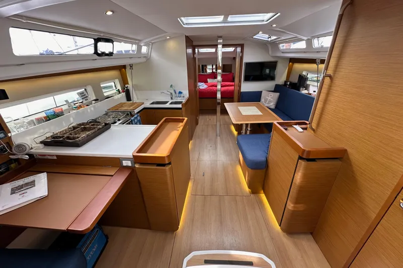  Yacht Photos Pics Interior of 2019 Jeanneau Sun Odyssey 440 yacht with modern kitchen and seating area.
