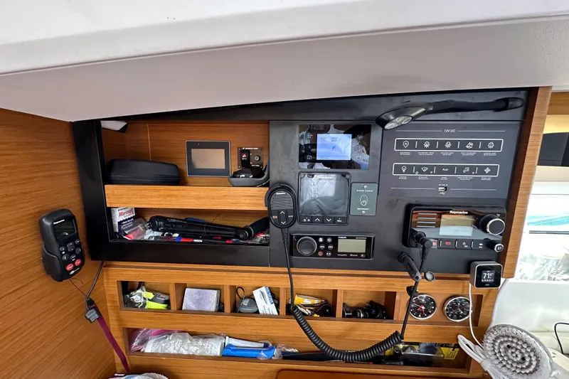  Yacht Photos Pics Control panel of 2019 Jeanneau Sun Odyssey 440 sailboat with navigation and communication equipment.