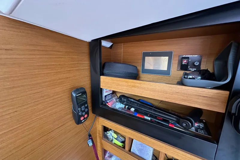  Yacht Photos Pics Interior of 2019 Jeanneau Sun Odyssey 440 with control panel and storage shelves.
