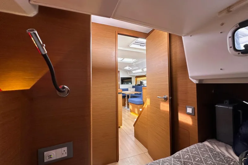  Yacht Photos Pics Interior of 2019 Jeanneau Sun Odyssey 440 yacht, featuring modern wood finish and cozy cabin.