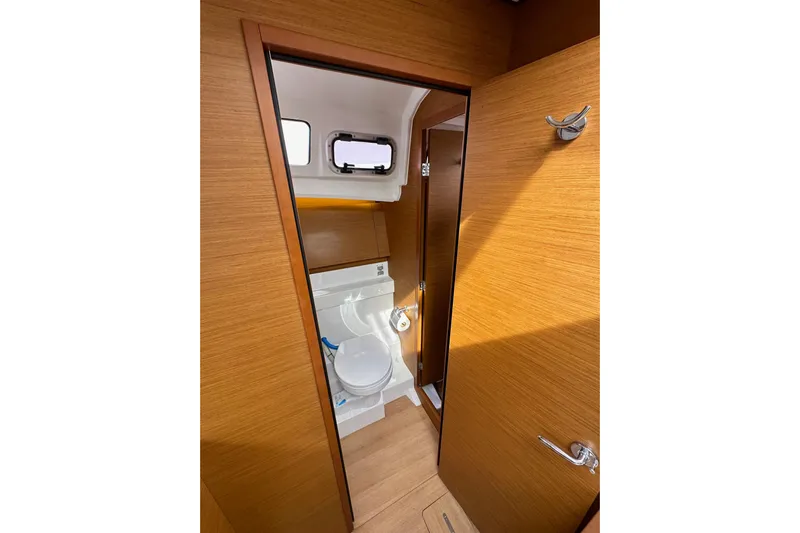  Yacht Photos Pics Interior view of 2019 Jeanneau Sun Odyssey 440 yacht bathroom with wooden finish.