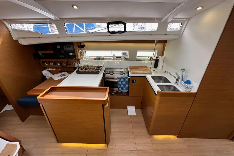  Yacht Photos Pics Interior of 2019 Jeanneau Sun Odyssey 440 yacht, featuring modern kitchen and navigation area.
