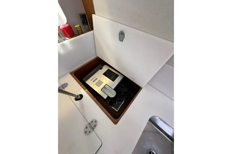 Yacht Photos Pics Hidden storage compartment in Jeanneau Sun Odyssey 440 yacht kitchen, featuring a coffee machine.