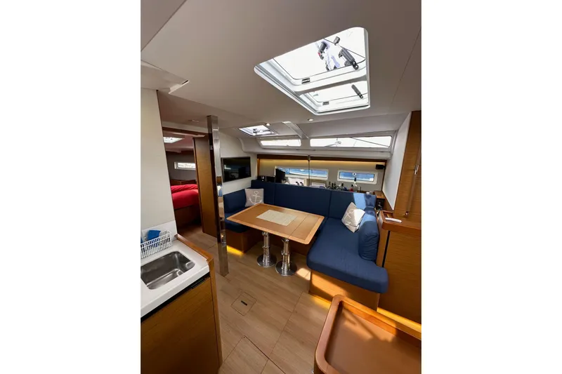  Yacht Photos Pics Interior of 2019 Jeanneau Sun Odyssey 440 yacht with modern seating and skylight.
