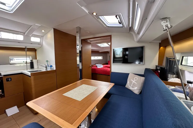  Yacht Photos Pics Interior of 2019 Jeanneau Sun Odyssey 440 yacht with modern kitchen and cozy seating area.