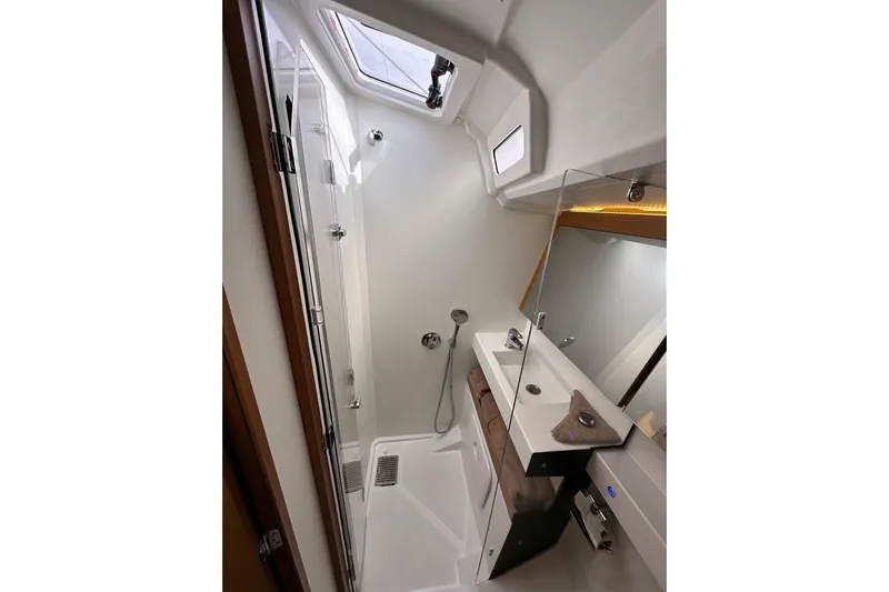  Yacht Photos Pics Modern bathroom in 2019 Jeanneau Sun Odyssey 440 yacht, featuring sleek design and fixtures.
