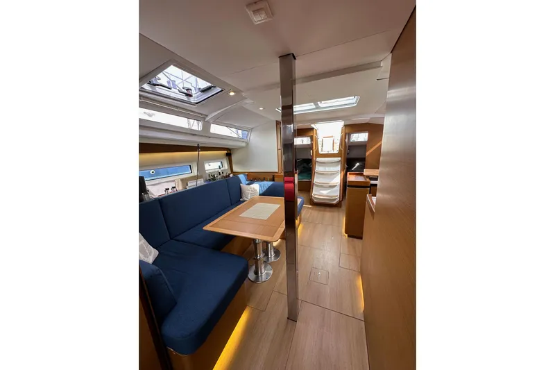  Yacht Photos Pics Interior of 2019 Jeanneau Sun Odyssey 440 sailboat with modern seating and wooden finishes.