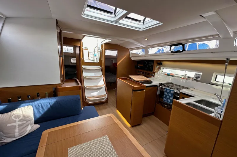  Yacht Photos Pics Interior of 2019 Jeanneau Sun Odyssey 440 sailboat, featuring modern kitchen and seating area.