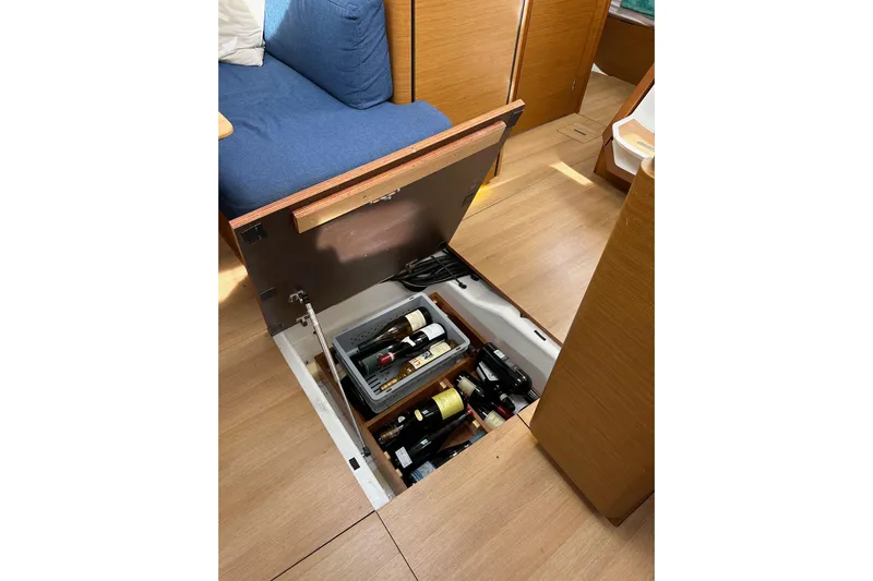  Yacht Photos Pics Hidden wine storage in 2019 Jeanneau Sun Odyssey 440 sailboat interior.