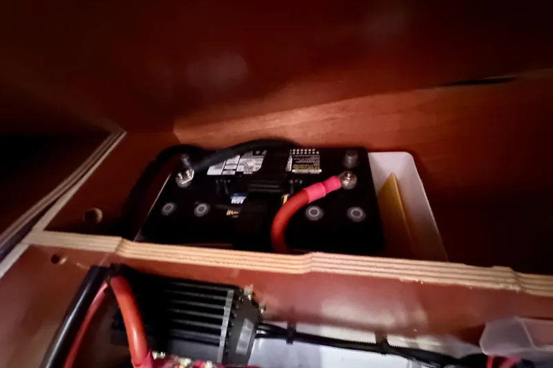  Yacht Photos Pics Battery compartment of a 2019 Jeanneau Sun Odyssey 440 sailboat, featuring wiring and connections.