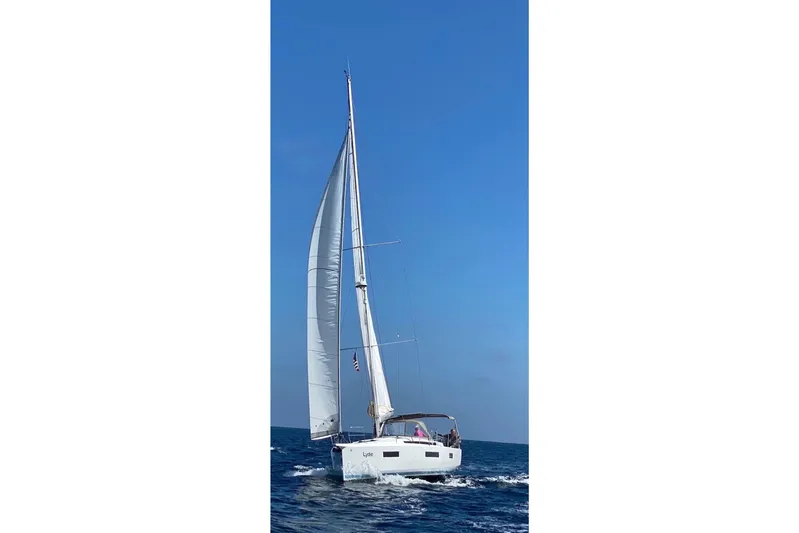  Yacht Photos Pics 2019 Jeanneau Sun Odyssey 440 sailing on open sea under clear blue sky.