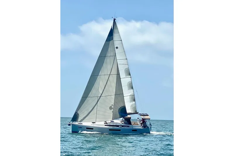  Yacht Photos Pics 2019 Jeanneau Sun Odyssey 440 sailing on open water under clear skies.