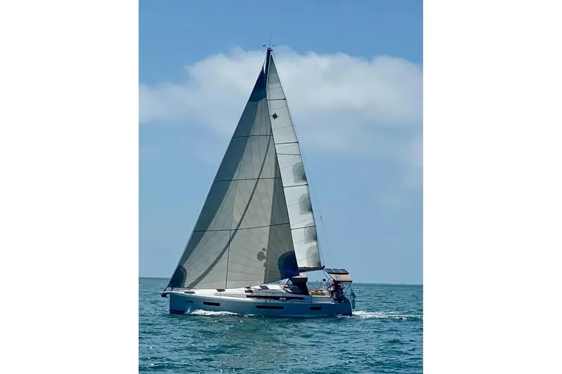  Yacht Photos Pics 2019 Jeanneau Sun Odyssey 440 sailing on open sea under clear blue sky.