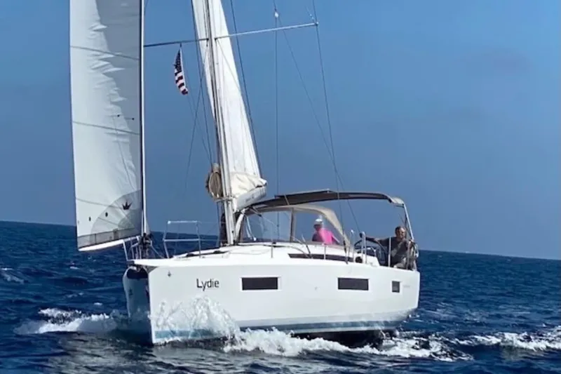  Yacht Photos Pics 2019 Jeanneau Sun Odyssey 440 sailing on open sea under clear blue sky.