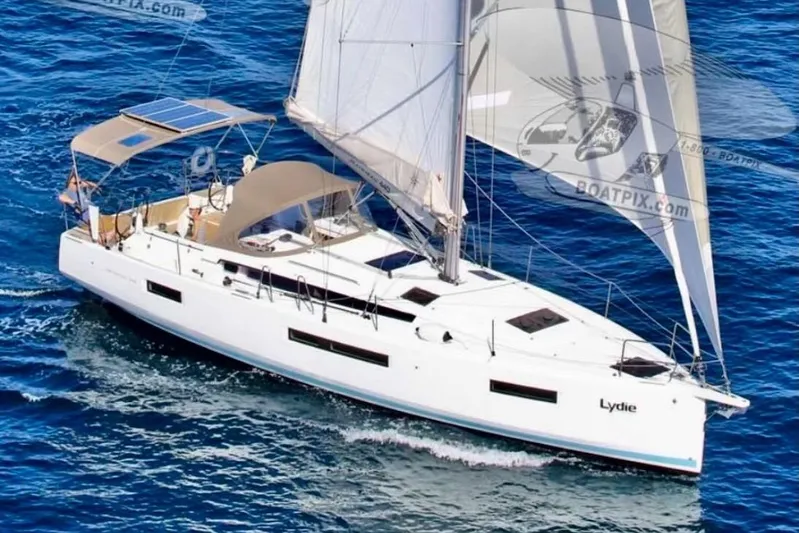 Yacht Photos Pics 2019 Jeanneau Sun Odyssey 440 sailing on open blue sea, elegant design and spacious deck.
