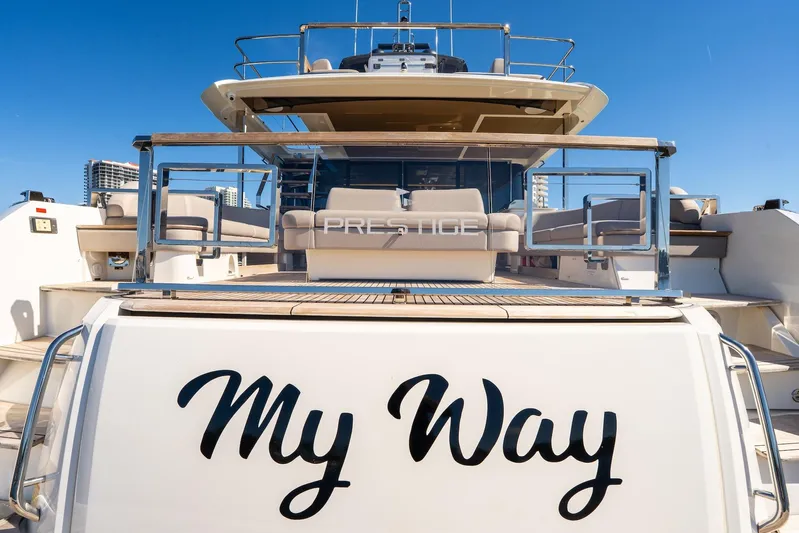  Yacht Photos Pics Luxury 2022 Prestige X70 yacht named "My Way" docked under clear blue sky.