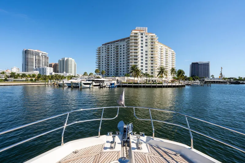  Yacht Photos Pics Bow view from 2022 Prestige X70 yacht, overlooking marina and waterfront buildings.
