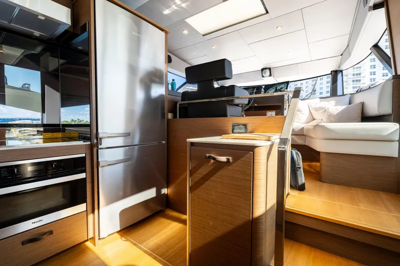  Yacht Photos Pics Luxurious interior of 2022 Prestige X70 yacht with modern kitchen and seating area.