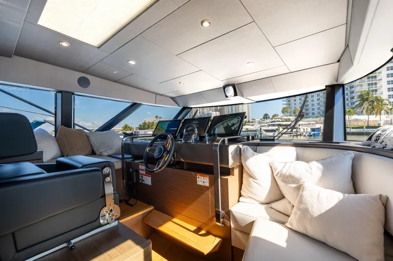  Yacht Photos Pics Luxurious interior of 2022 Prestige X70 yacht with modern helm and plush seating.