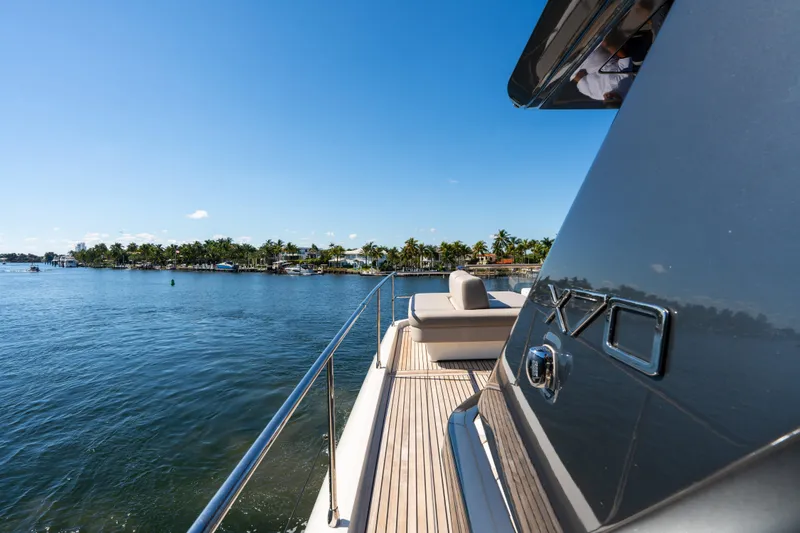  Yacht Photos Pics Luxury 2022 Prestige X70 yacht on serene water with clear blue sky.