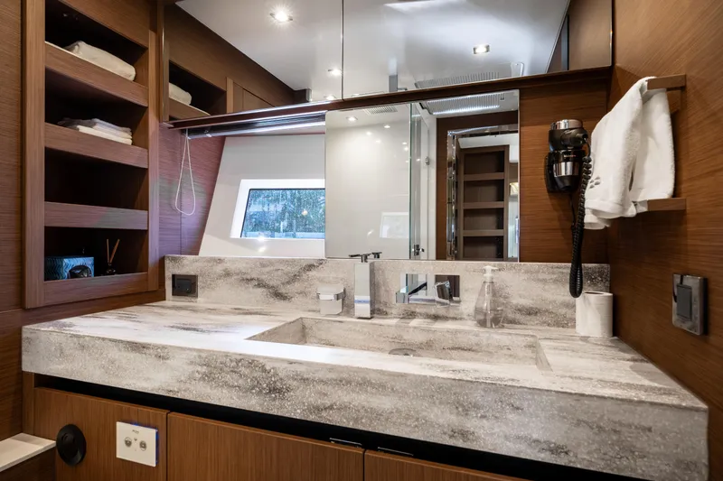  Yacht Photos Pics Luxurious bathroom in 2022 Prestige X70 yacht with modern fixtures and wooden accents.