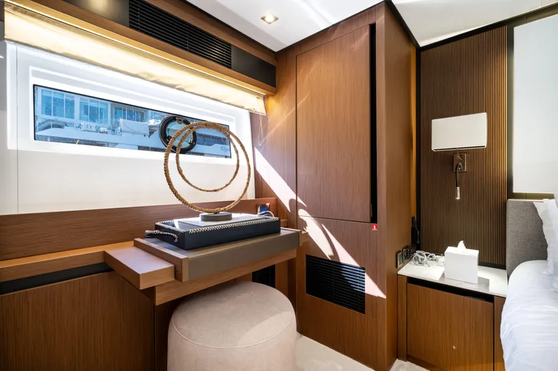  Yacht Photos Pics Luxurious interior of 2022 Prestige X70 yacht with modern wooden decor and elegant furnishings.