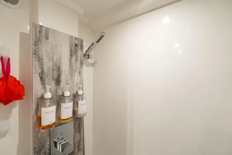  Yacht Photos Pics Modern shower with mounted dispensers in a 2022 Prestige X70 yacht bathroom.