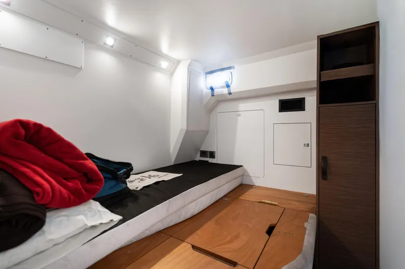  Yacht Photos Pics 2022 Prestige X70 yacht cabin interior with bed, storage, and modern lighting.