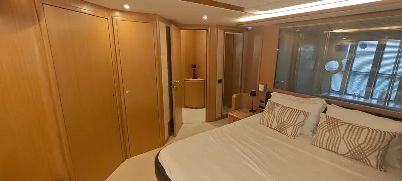 Yacht Photos Pics Luxurious bedroom interior of 2009 Ferretti Yachts 830 with wood paneling and modern design.