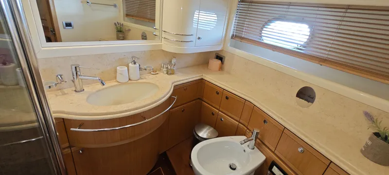  Yacht Photos Pics Luxurious bathroom in 2009 Ferretti Yachts 830, featuring elegant fixtures and wooden cabinetry.
