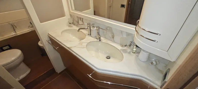  Yacht Photos Pics Luxurious bathroom in 2009 Ferretti Yachts 830 with dual sinks and elegant fixtures.