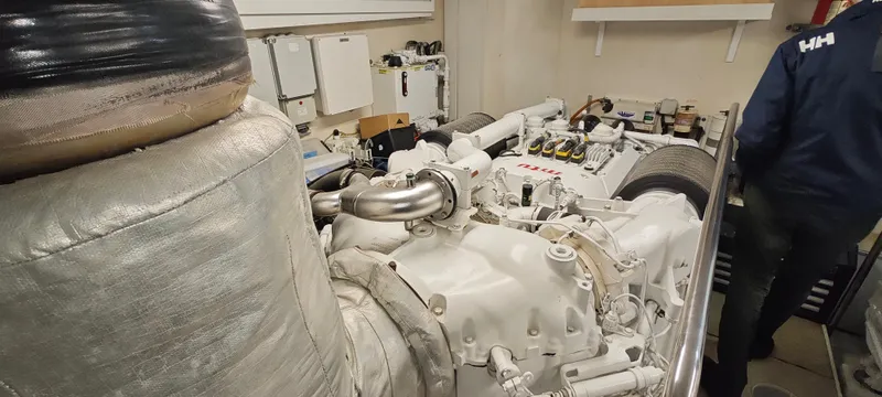  Yacht Photos Pics Engine room of a 2009 Ferretti Yachts 830, showcasing mechanical components and insulation.
