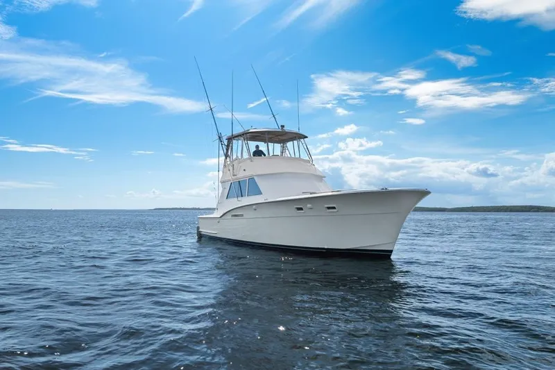 Bella Yacht Photos Pics 1978 Hatteras 45 Convertible yacht on open water under a clear blue sky.
