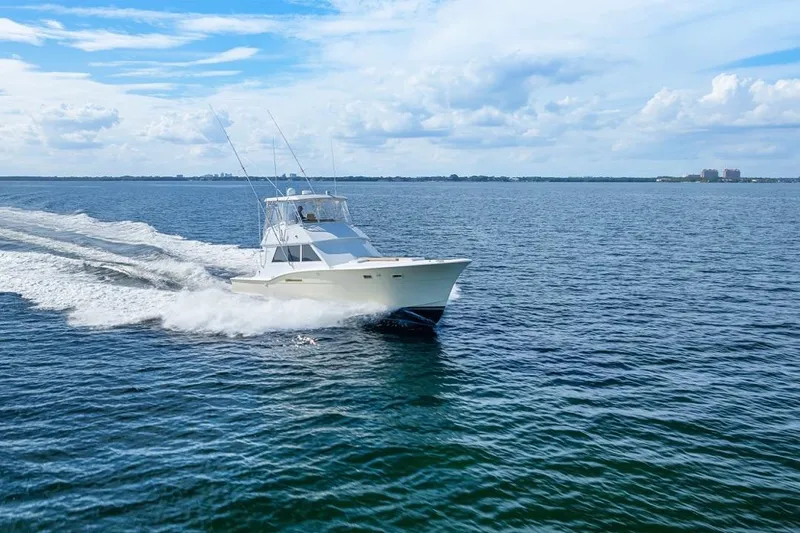 Bella Yacht Photos Pics 1978 Hatteras 45 Convertible yacht cruising on open water under a blue sky.