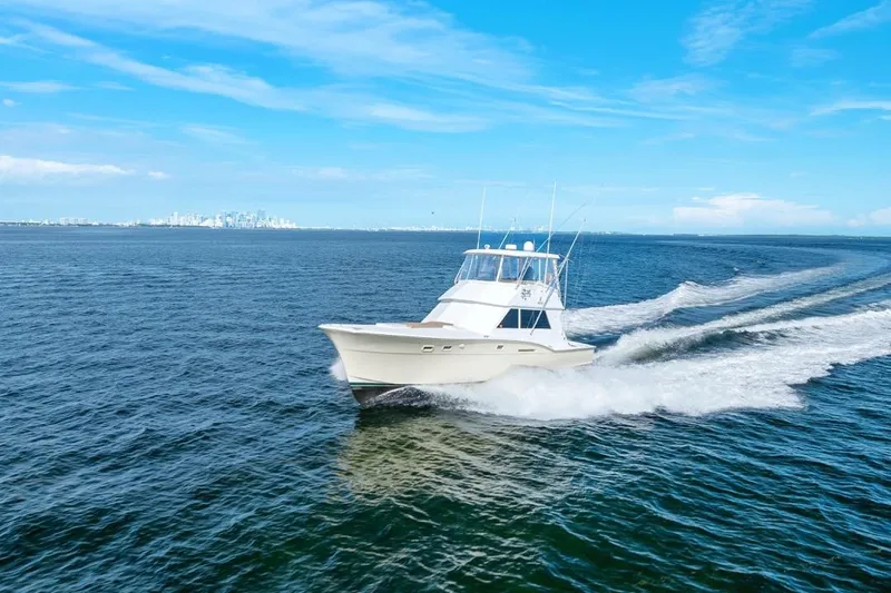 Bella Yacht Photos Pics 1978 Hatteras 45 Convertible yacht cruising on open blue sea under clear sky.