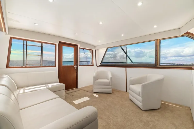 Bella Yacht Photos Pics Luxurious interior of 1978 Hatteras 45 Convertible yacht with panoramic ocean views.
