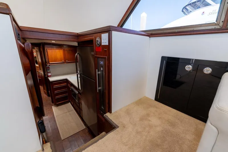 Bella Yacht Photos Pics Interior of 1978 Hatteras 45 Convertible yacht with modern kitchen and wood cabinetry.