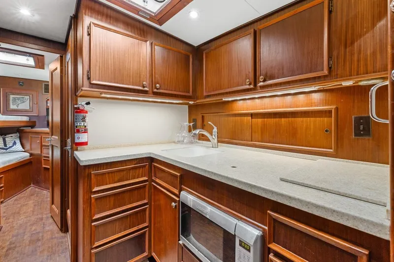 Bella Yacht Photos Pics 1978 Hatteras 45 Convertible yacht kitchen with wood cabinets and modern appliances.