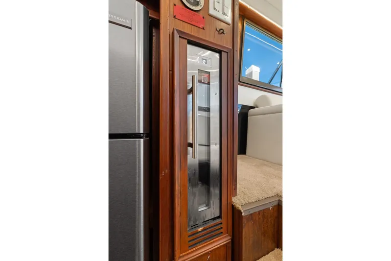 Bella Yacht Photos Pics Interior of 1978 Hatteras 45 Convertible yacht with wooden paneling and modern appliances.