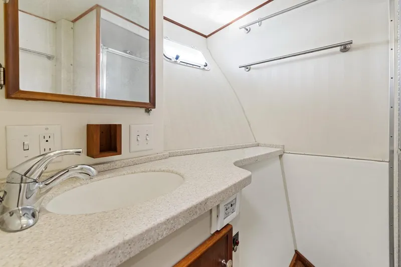 Bella Yacht Photos Pics Bathroom interior of 1978 Hatteras 45 Convertible yacht with sink and mirror.