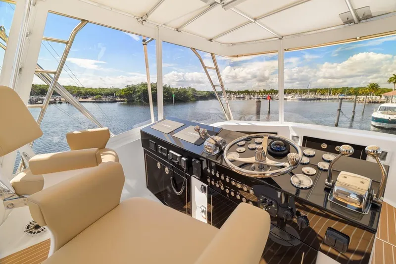 Bella Yacht Photos Pics Helm of 1978 Hatteras 45 Convertible yacht with scenic marina view.