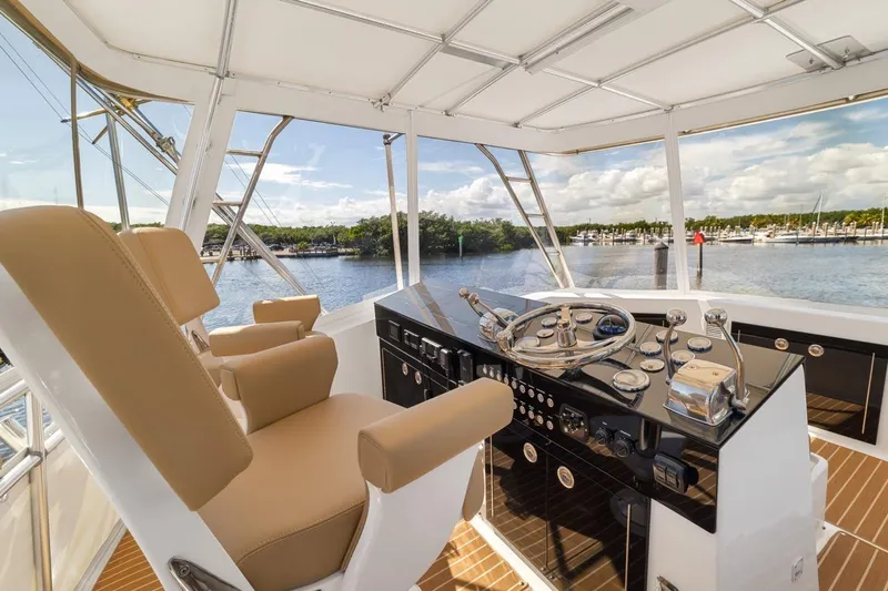 Bella Yacht Photos Pics 1978 Hatteras 45 Convertible yacht helm with tan seats and scenic marina view.