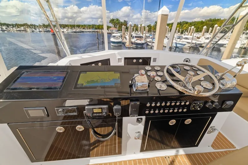 Bella Yacht Photos Pics Cockpit of 1978 Hatteras 45 Convertible yacht with navigation equipment and steering wheel.
