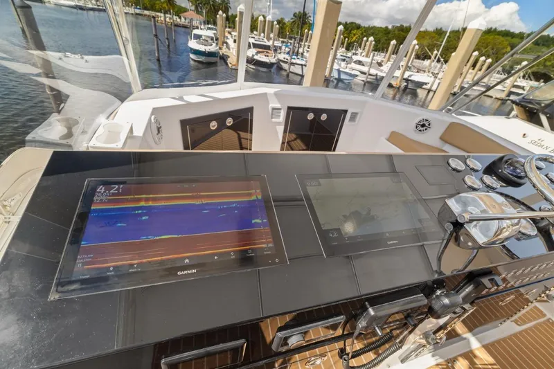 Bella Yacht Photos Pics 1978 Hatteras 45 Convertible yacht helm with Garmin navigation displays at marina.