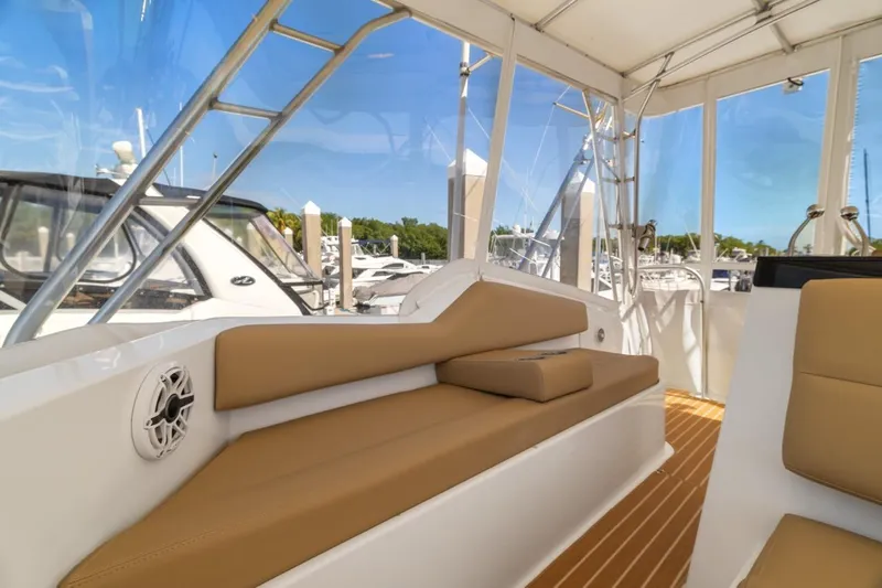 Bella Yacht Photos Pics 1978 Hatteras 45 Convertible yacht interior with tan seating and marina view.