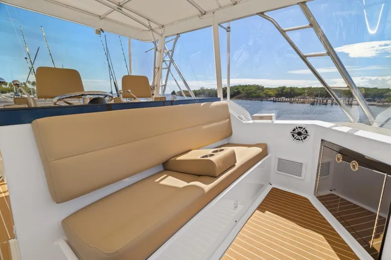 Bella Yacht Photos Pics 1978 Hatteras 45 Convertible yacht interior with tan seating and scenic water view.