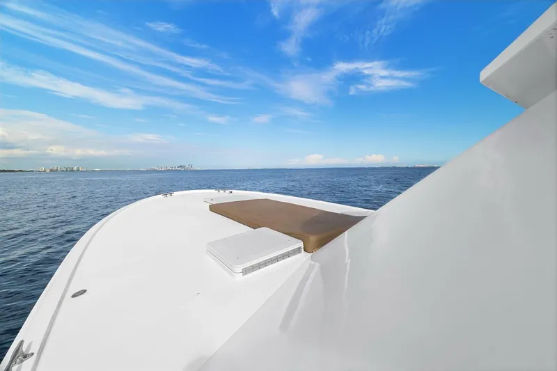 Bella Yacht Photos Pics 1978 Hatteras 45 Convertible yacht on open water under clear blue sky.