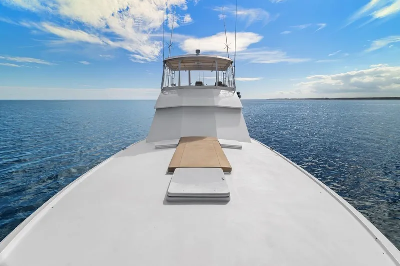 Bella Yacht Photos Pics 1978 Hatteras 45 Convertible yacht on open sea under blue sky.
