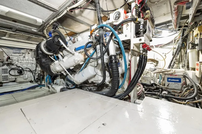 Bella Yacht Photos Pics Engine room of a 1978 Hatteras 45 Convertible yacht, showcasing mechanical components.