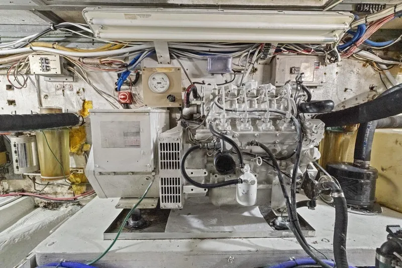 Bella Yacht Photos Pics Engine room of a 1978 Hatteras 45 Convertible boat, showcasing detailed machinery.